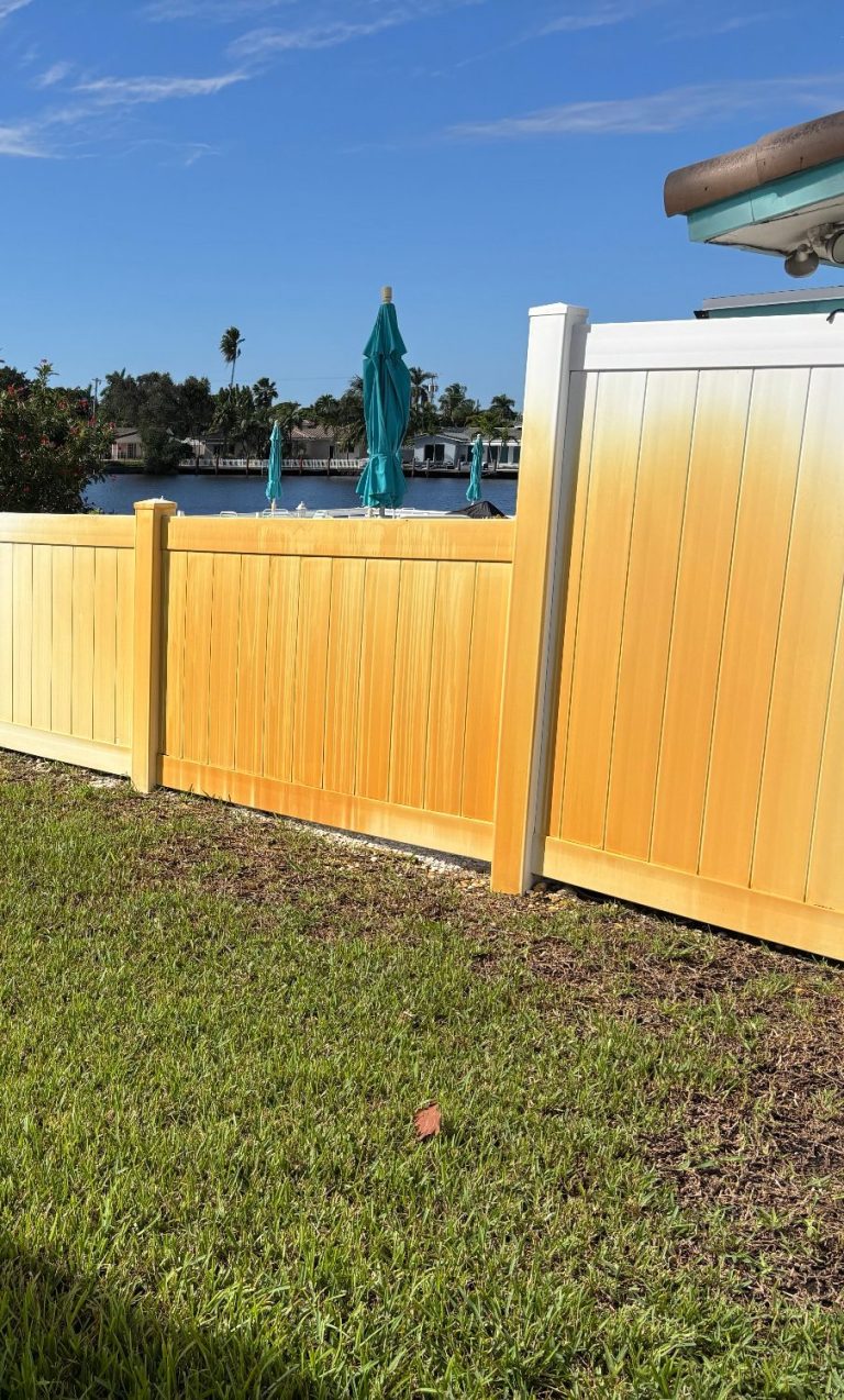 Before photo of a Rust stained fence at one of our client's property. Photo of a badly rust stained vinyl fencing along the backyard that has not been treated with rust removal chemical.